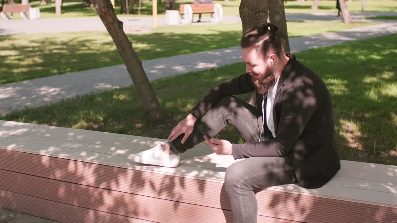 Cheerful Bearded Man Chatting on Video Call in Park
