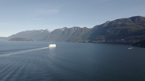 aerial view of a vessel sailing in canadian ocean, british columbia ferry services in vancouver, cruise in mountains bay with stunning natural unpolluted seascape