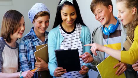 group of students using digital tablet in classroom