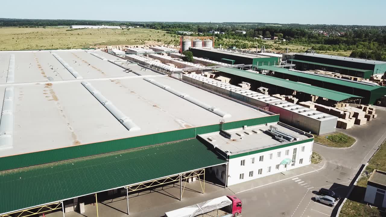 Aerial view of the woodworking factory outside the city. Camera motion to backwards