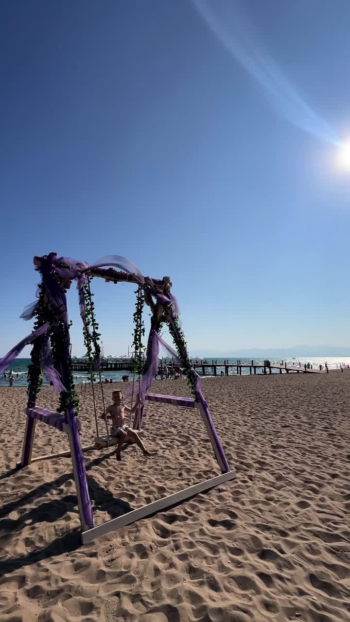 Child playing on a swing at the beach