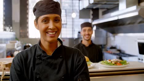 female chef smiling in commercial kitchen 4k
