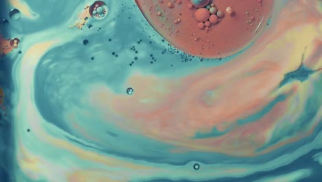 very colorful fluid paint moving around creating abstract art