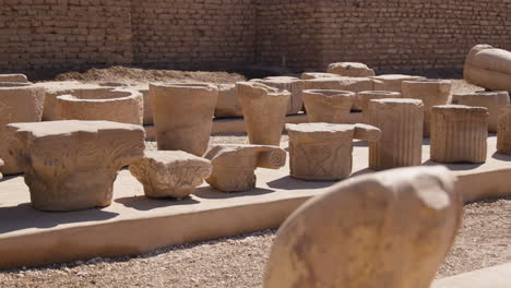 ancient stone pillars, remnants of a historical site in dendera, egypt, lit by sunlight