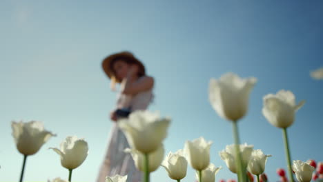 beautiful woman with photocamera taking time at woman hobby in park with flowers