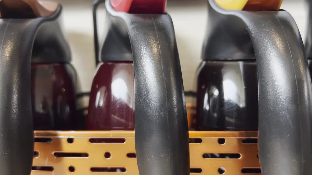 Several coffee pots standing in a metal rack, ready to serve customers in a Mexican restaurant, showcasing a blend of functionality and Mexican hospitality