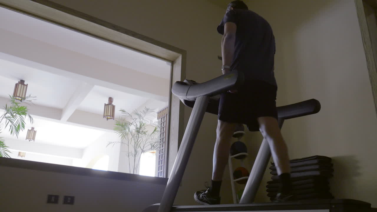 Man in the gym exercising on treadmill