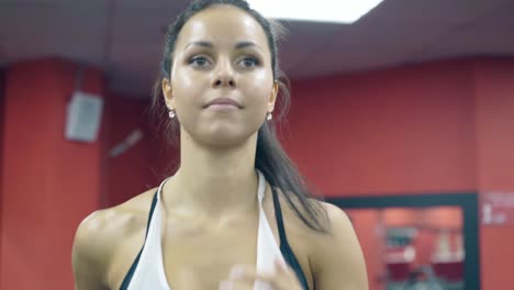 close-view-cute-brunette-girl-runs-on-modern-treadmill