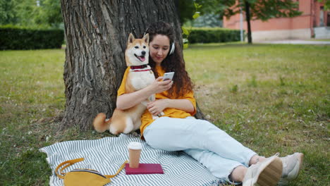 woman and dog relaxing in a park