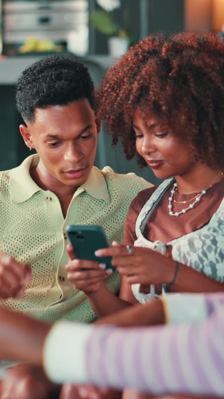 Young Couple Laughing and Sharing Content on Smartphone