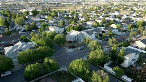 Single-family-homes-in-a-suburban-neighborhood-then-aerial-tilt-up-to-reveal-a-view-of-the-Rocky-Mountains