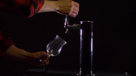 bartender pours beer into glass