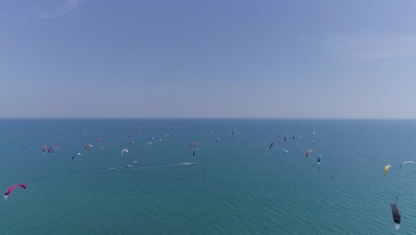 lots of kitesurfers in the mediterranean sea, view by drone.