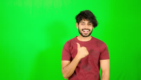 indian guy point out with green background indian guy standing on green screen - chroma key