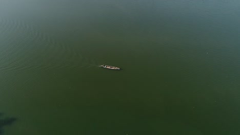 Drone-footage-of-a-lake-with-one-boat-travelling