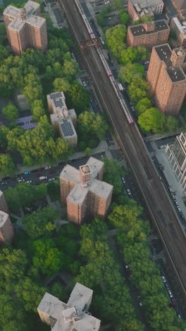 cars driving on street between high rise buildings