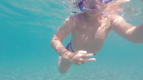 underwater footage of kid snorkeling at kalamata beach, greece