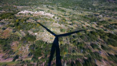 aerial drone shot of the rotating wind turbine