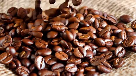 a heart shaped pile of coffee beans on a burlap bag