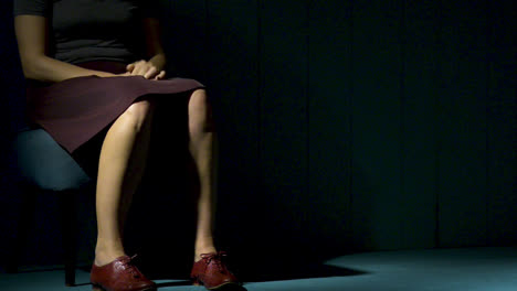 Woman-sitting-quickly-on-an-old-chair-in-a-room