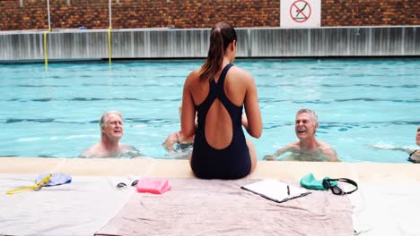 Swim coach interacting with seniors