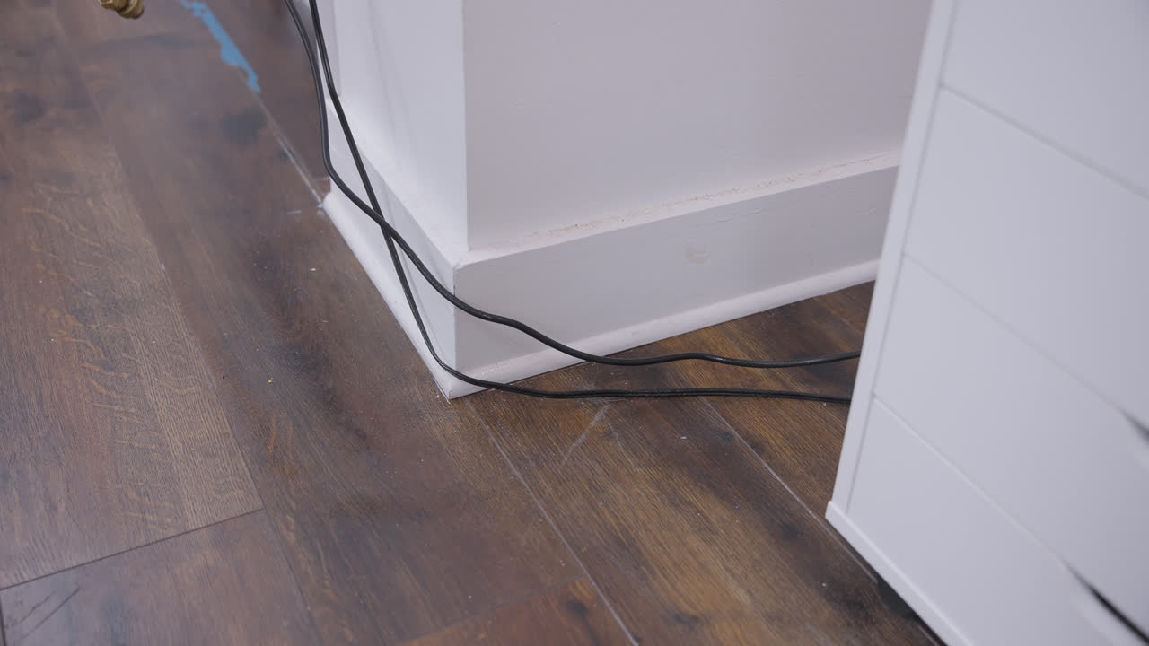 Final pass of pesticide application along clean office baseboards and flooring