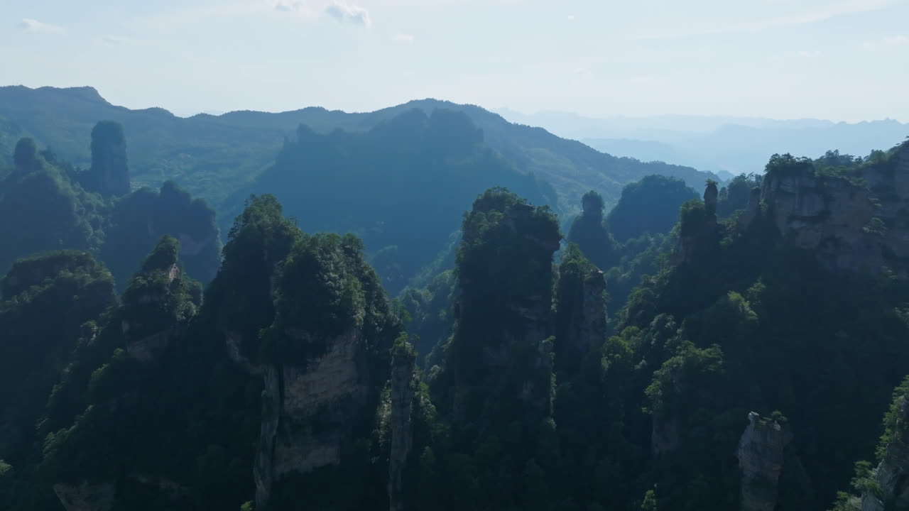 Establishing drone shot of karst mountain forest in sunny Zhangjiajie, China