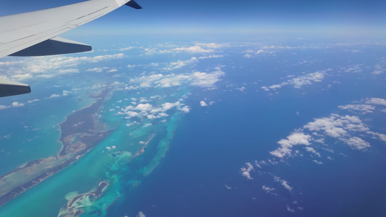 Experience a breathtaking aerial view of the Caribbean Sea during a flight from Toronto, Canada, to Jamaica