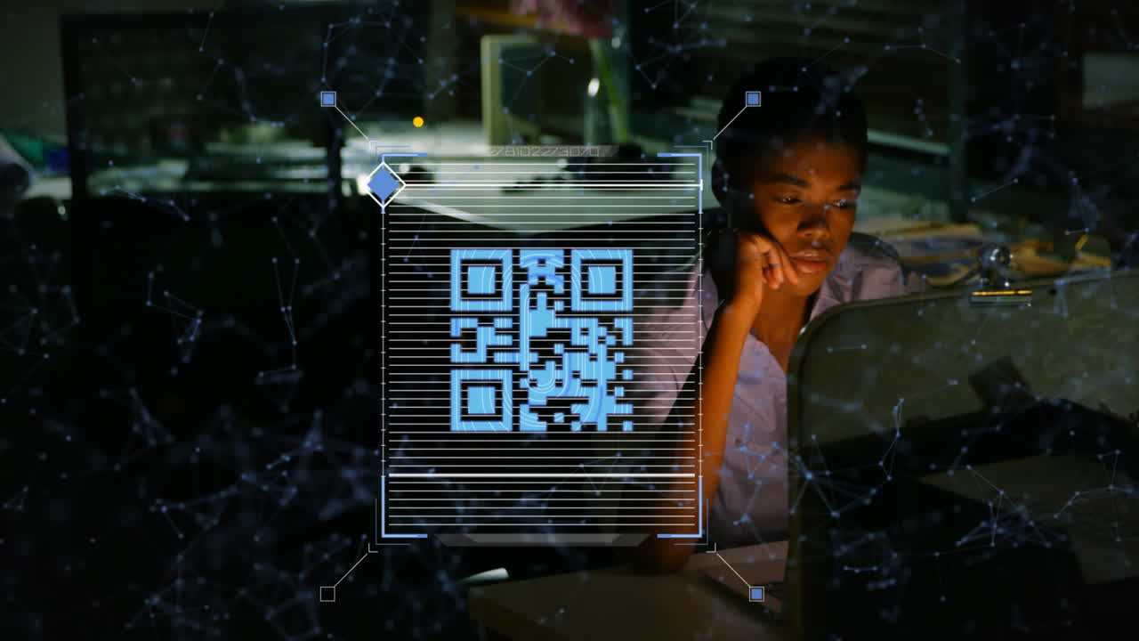 Animation of qr data processing over african american businesswoman with computer in office