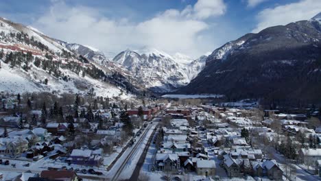 drone flyover of main street in telluride, colorado on a partly cloudy day