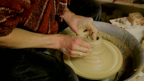 professional male potter making ceramics in workshop