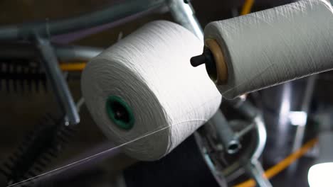 close-up shot of spools with white thread at rewinding machine video