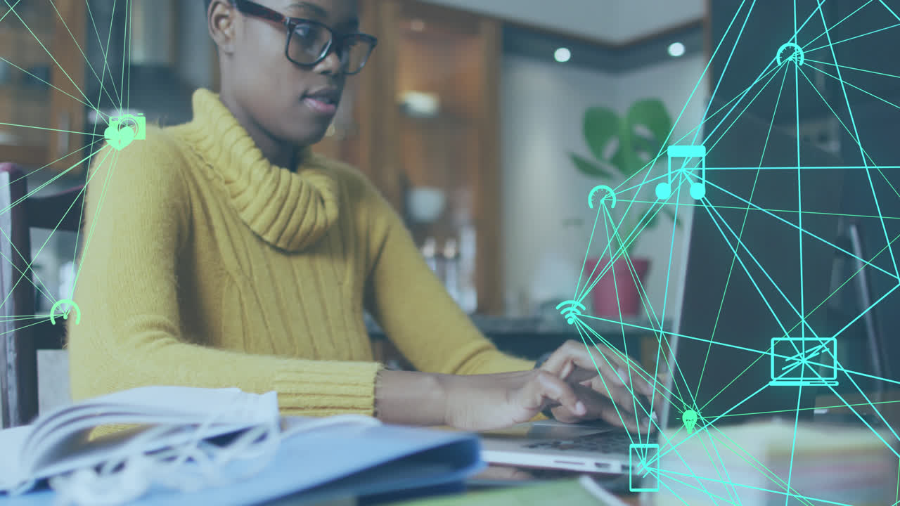 Animation of network of connections with icons over african american woman using laptop
