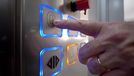 Close-up-of-the-illuminated-buttons-inside-a-modern-elevator,-showing-the-floor-numbers