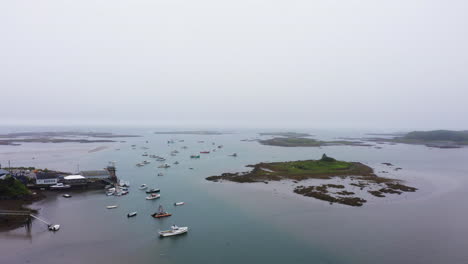 drone shot of marina in maine with lobster fishing boats and empty pier 4k 30p