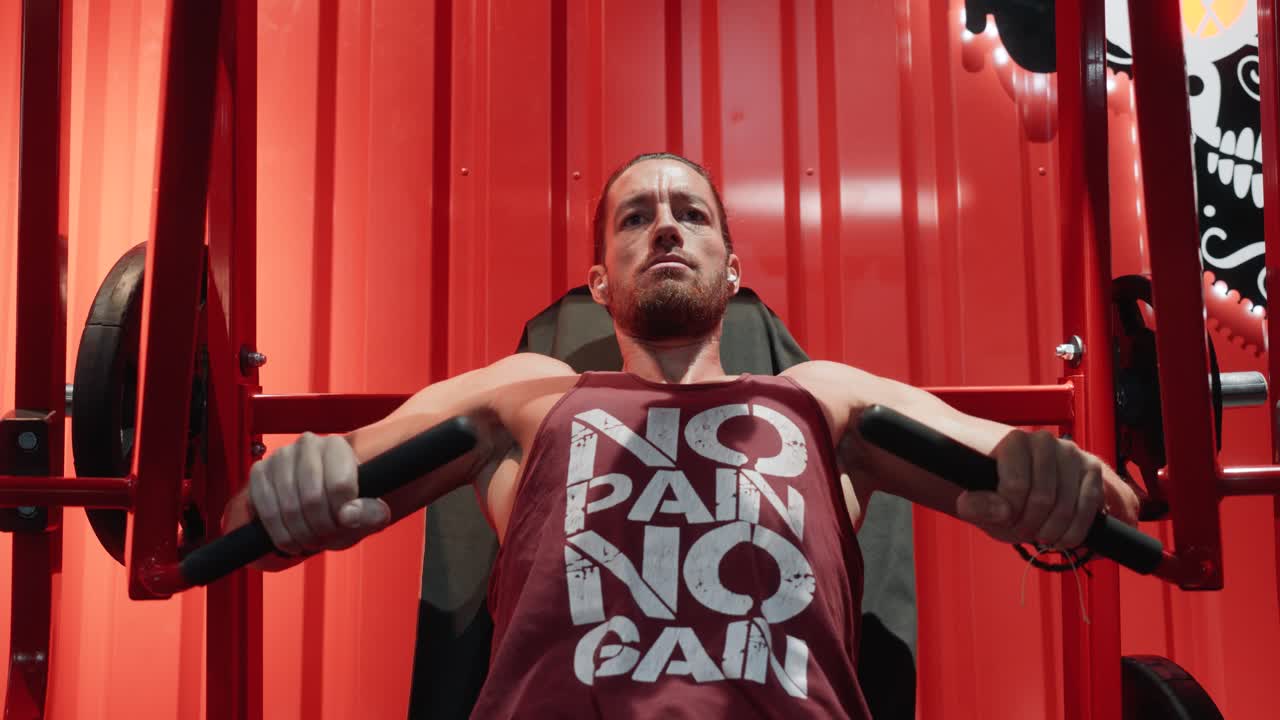 close-up shot of a handsome young Caucasian man doing weight training