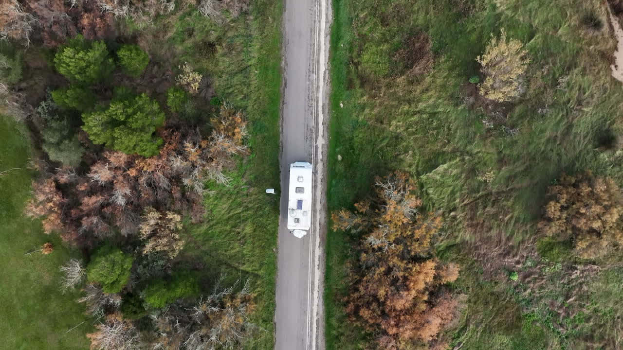 Motor home camper van driving scenic rural country road, Top down aerial view