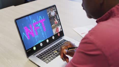 african american businessman using laptop for video call with diverse business colleagues