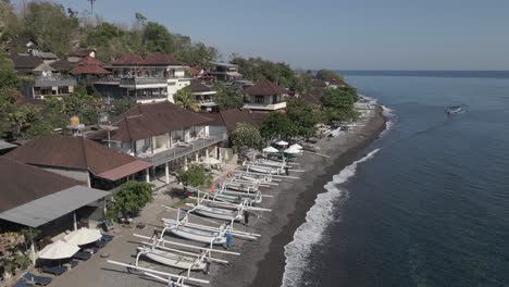 flyover of outrigger canoes on pebbled jemeluk beach on bali indonesia