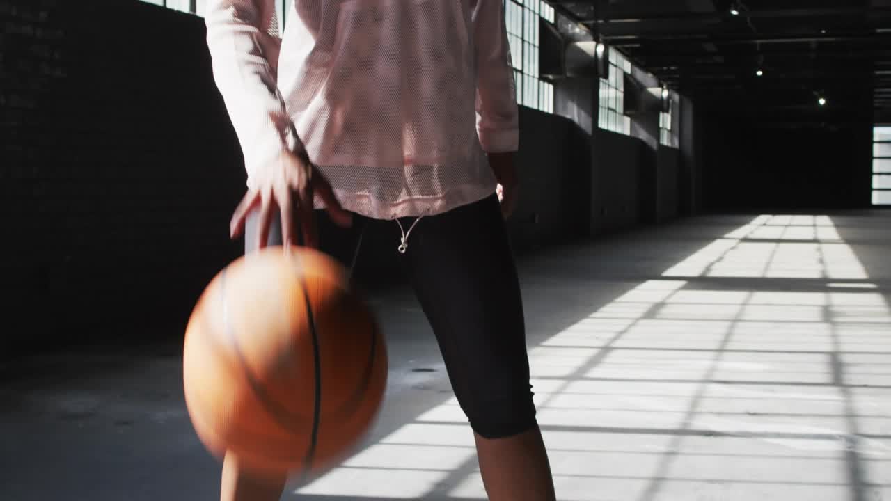 Woman catching basketball entering, stepping to hip and posing, emojis floating in front for sports