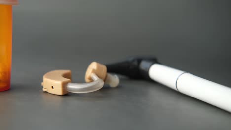 hearing aid equipment on orange background