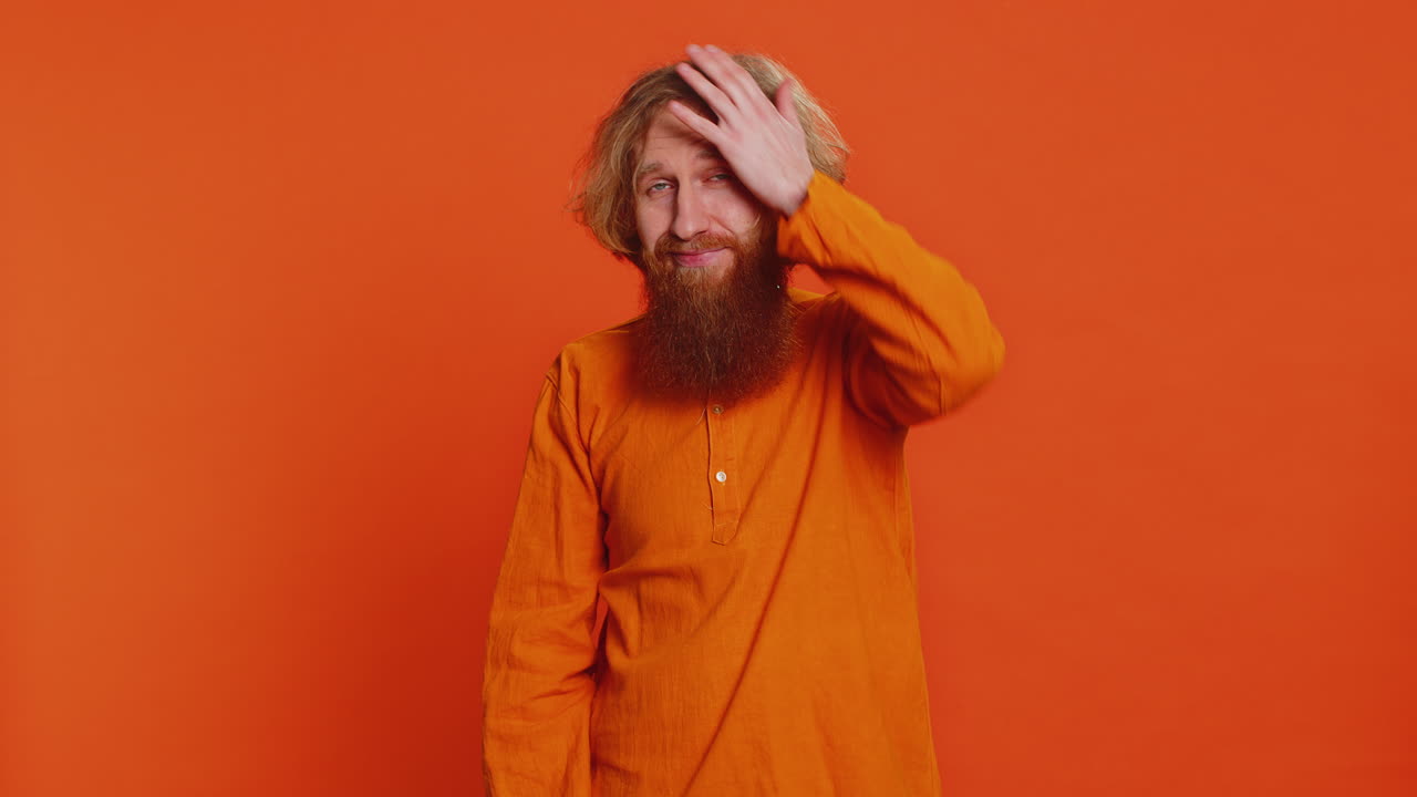Caucasian young man making face palm gesture feeling bored disappointed in result bad news quarrel
