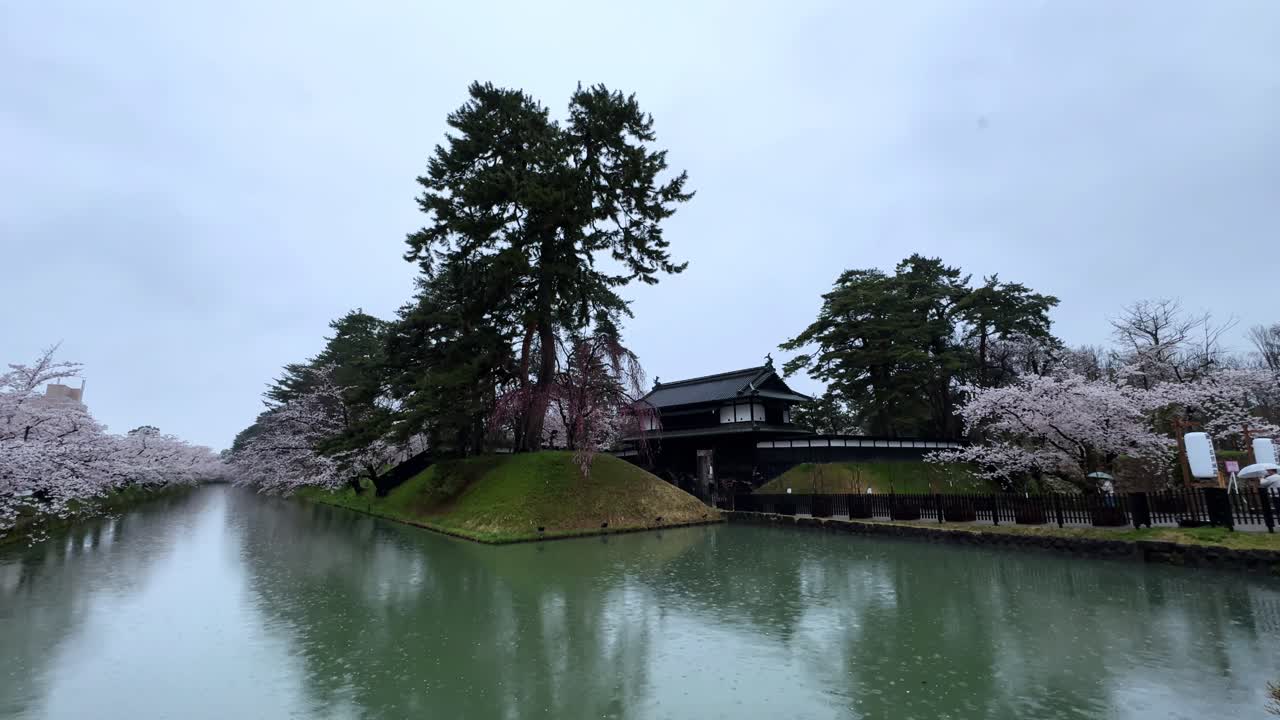 Scenic view of Hirosaki Castle surrounded by blooming cherry blossoms during spring