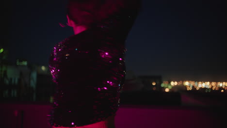 beautiful-woman-dancing-on-rooftop-brazilian-woman-performing-latin-dance-moves-in-city-at-night-with-red-light