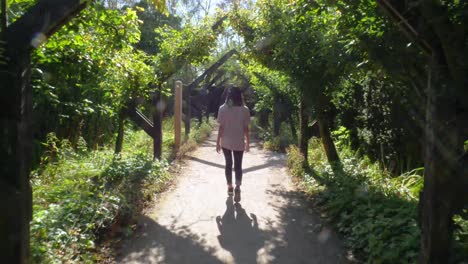 Shot-Following-a-Young-Woman-Through-a-Pristine-Garden