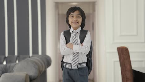 Happy-Indian-school-boy-standing-crossed-hands