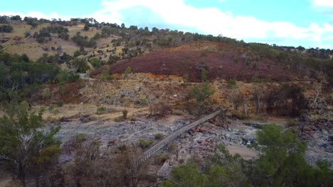 Wide-orbit-view-of-Bells-Rapids-bridge-Perth,-showing-dry-rocky-riverbed