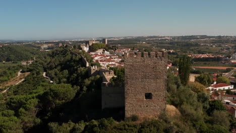 Reveal-Aerial-Shot-of-the-Medieval-Fortified-City-of-Obidos,-Portugal