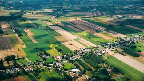 Aerial-view-of-green-fields-and-sun-in-the-sky