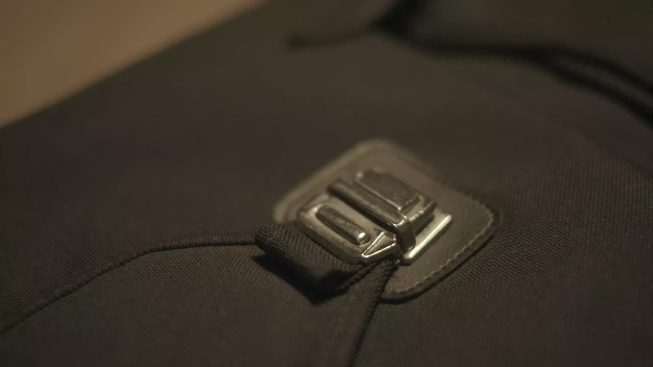 Close-up of a Hand Fastening a Bag Clasp